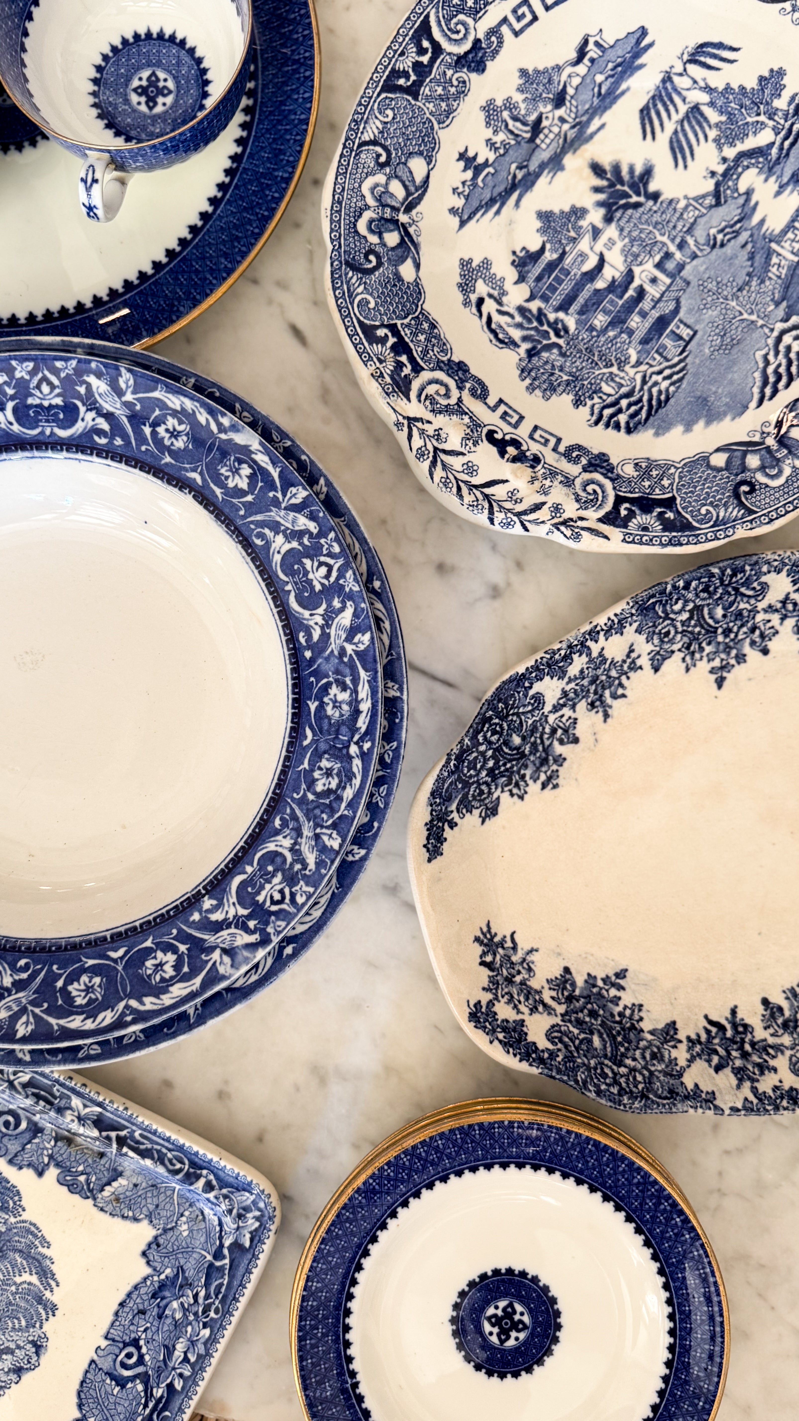 Antique English Low Bowl in a collection of other blue & white patterned platters/plates.