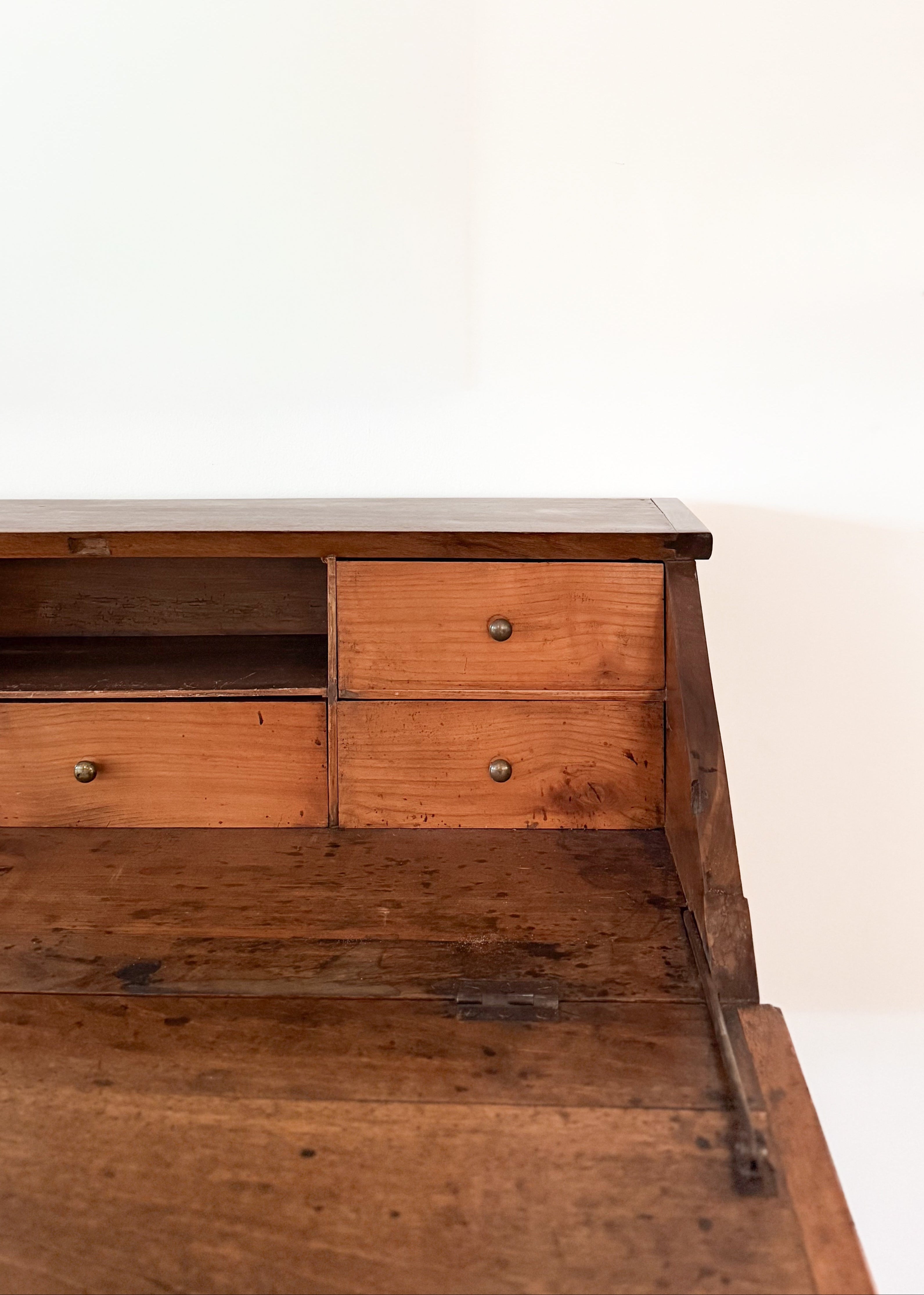 Antique wooden desk with two drawers on a white background