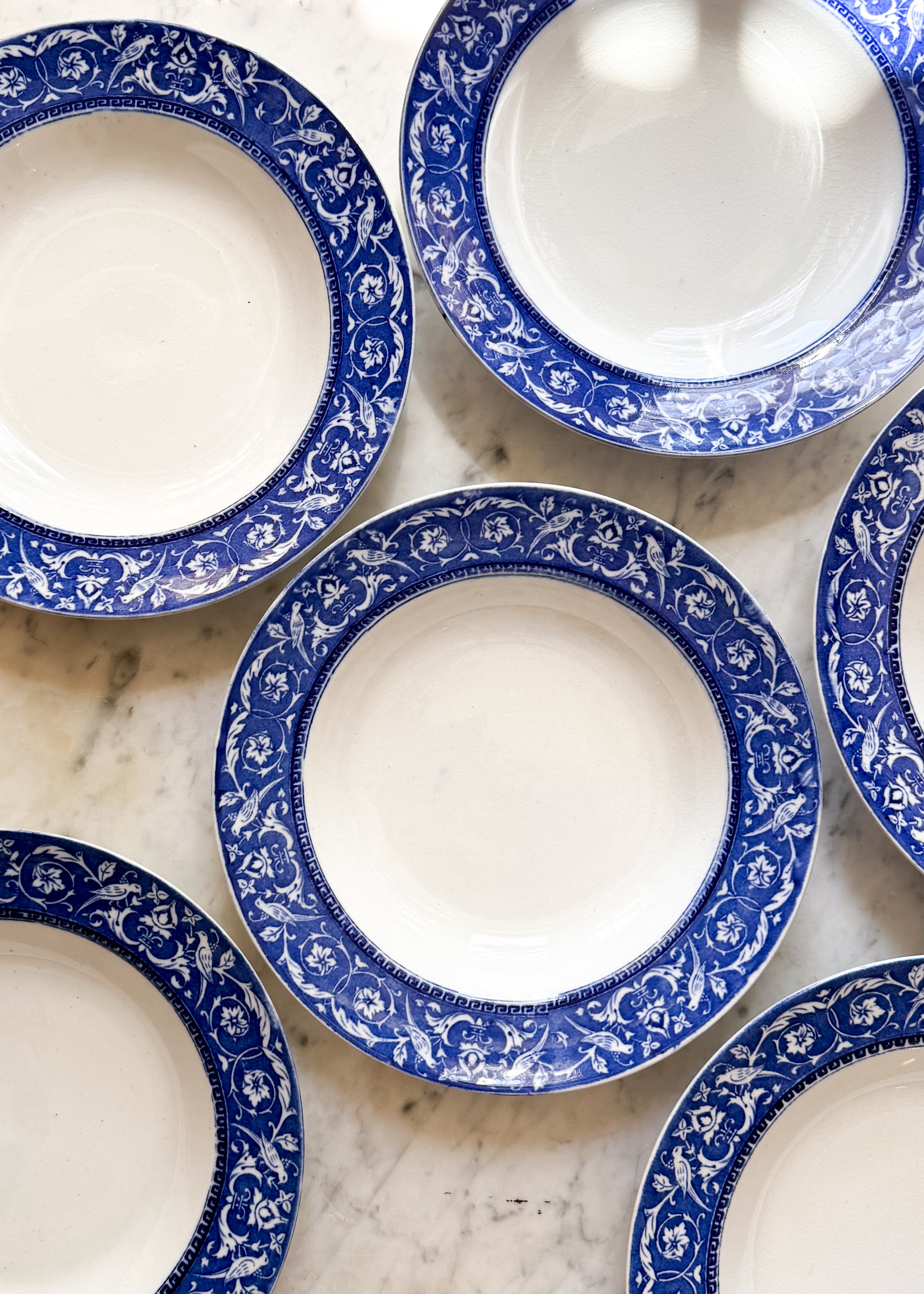 Six of the Antique English Low Bowls set on a marble counter.