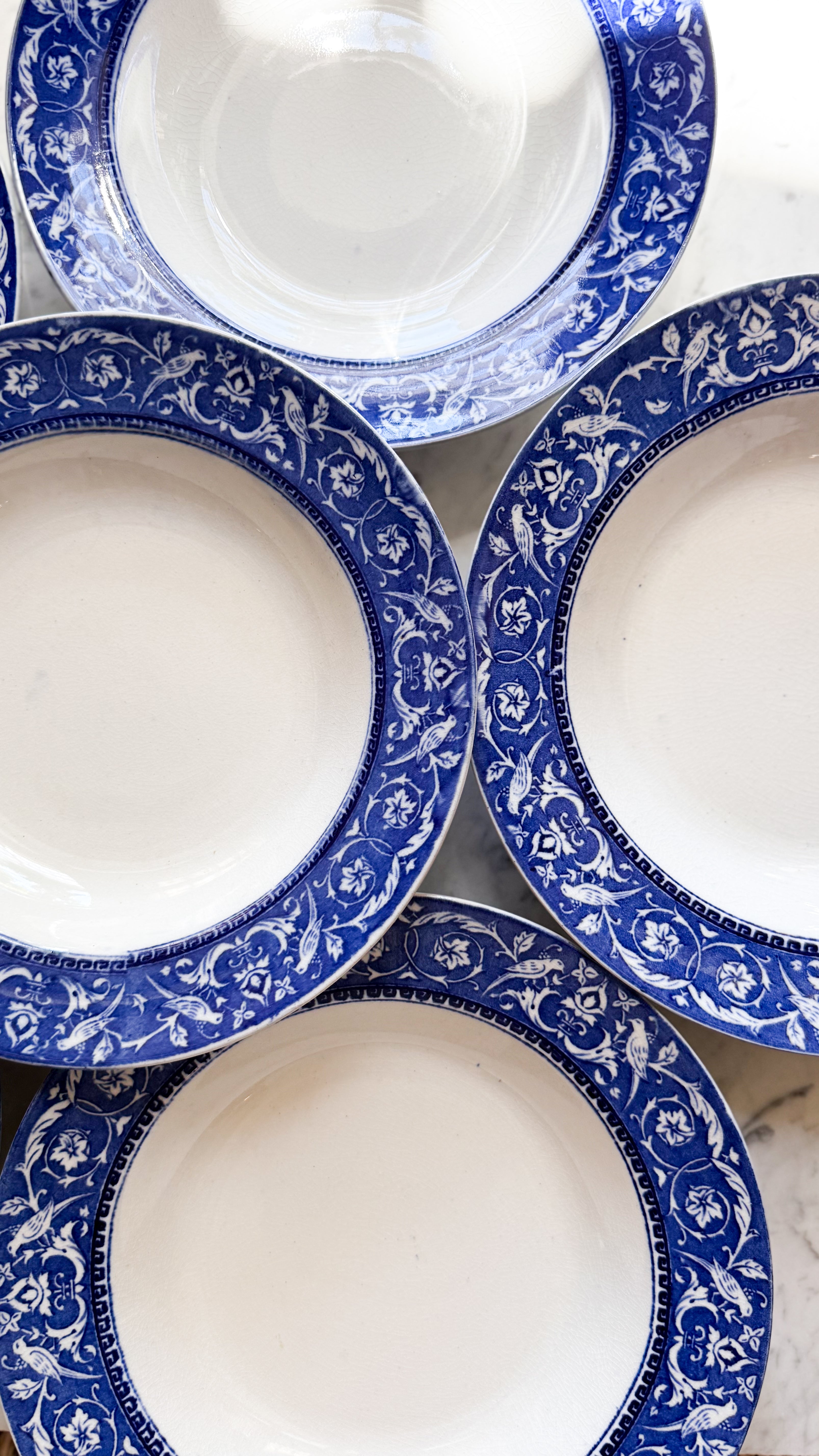  Four Antique English Low Bowls set out on a marble counter.