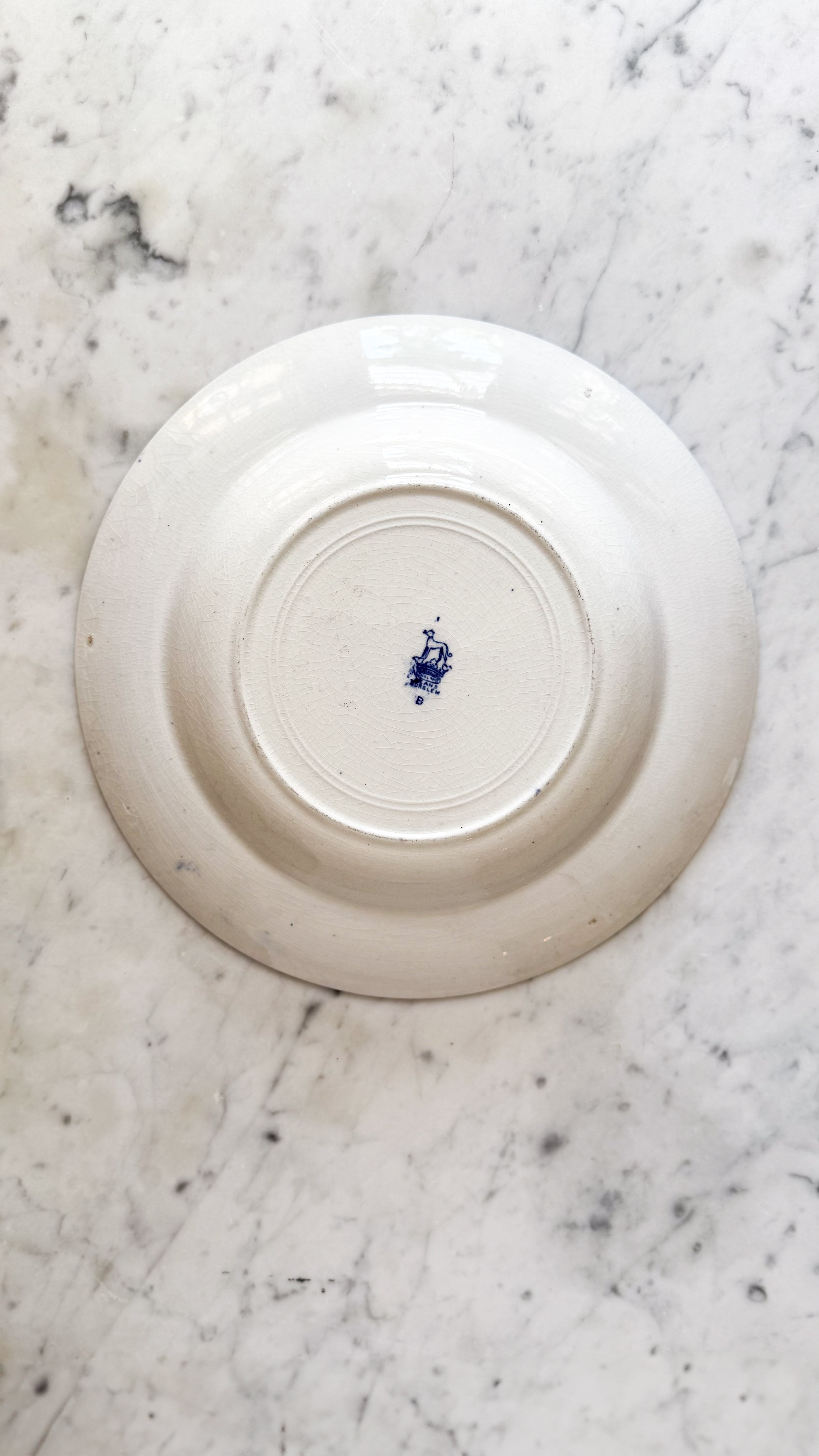 The bottom of Antique English Low Bowl on top of a marble counter