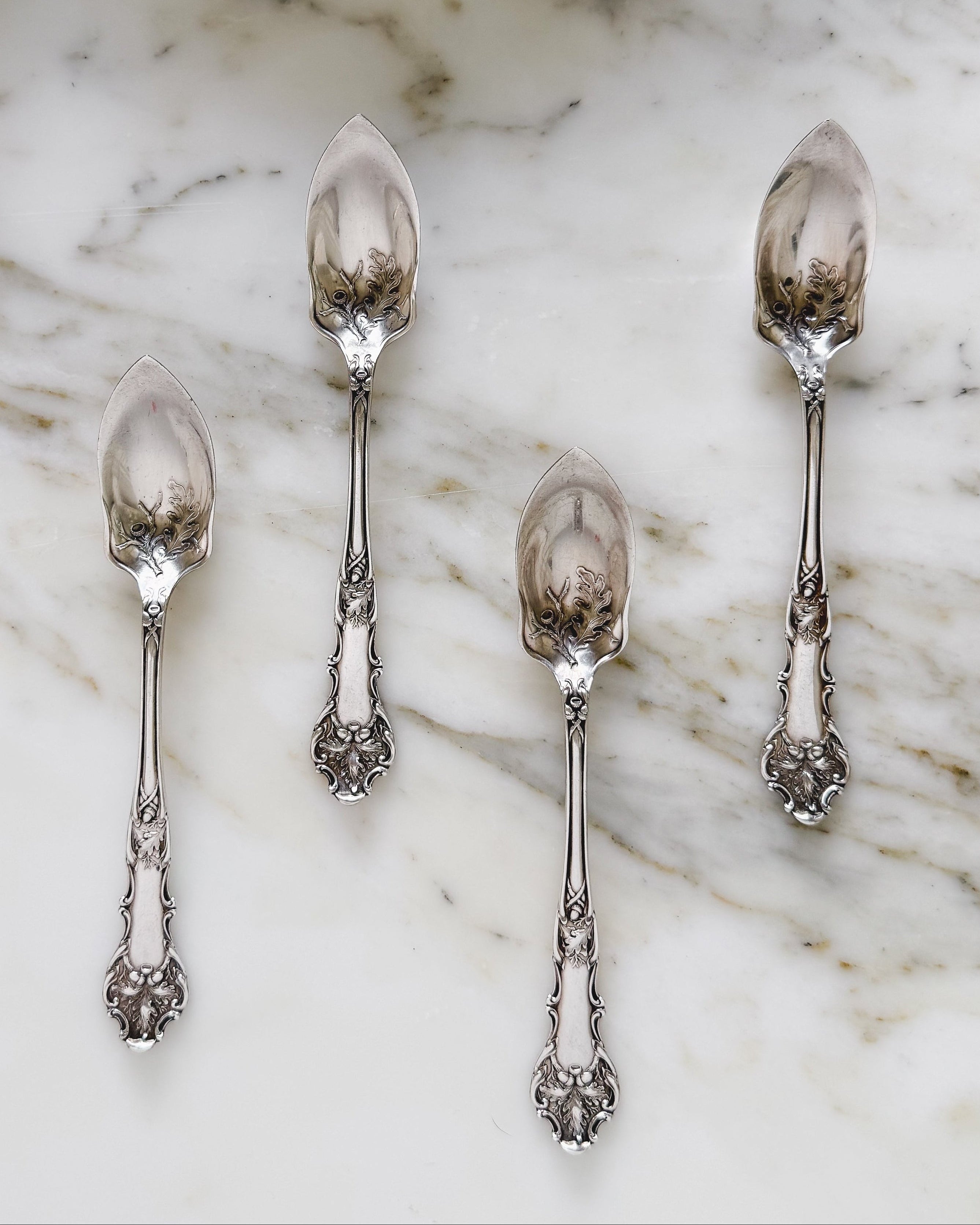 Antique silver grapefruit spoon set in oak pattern